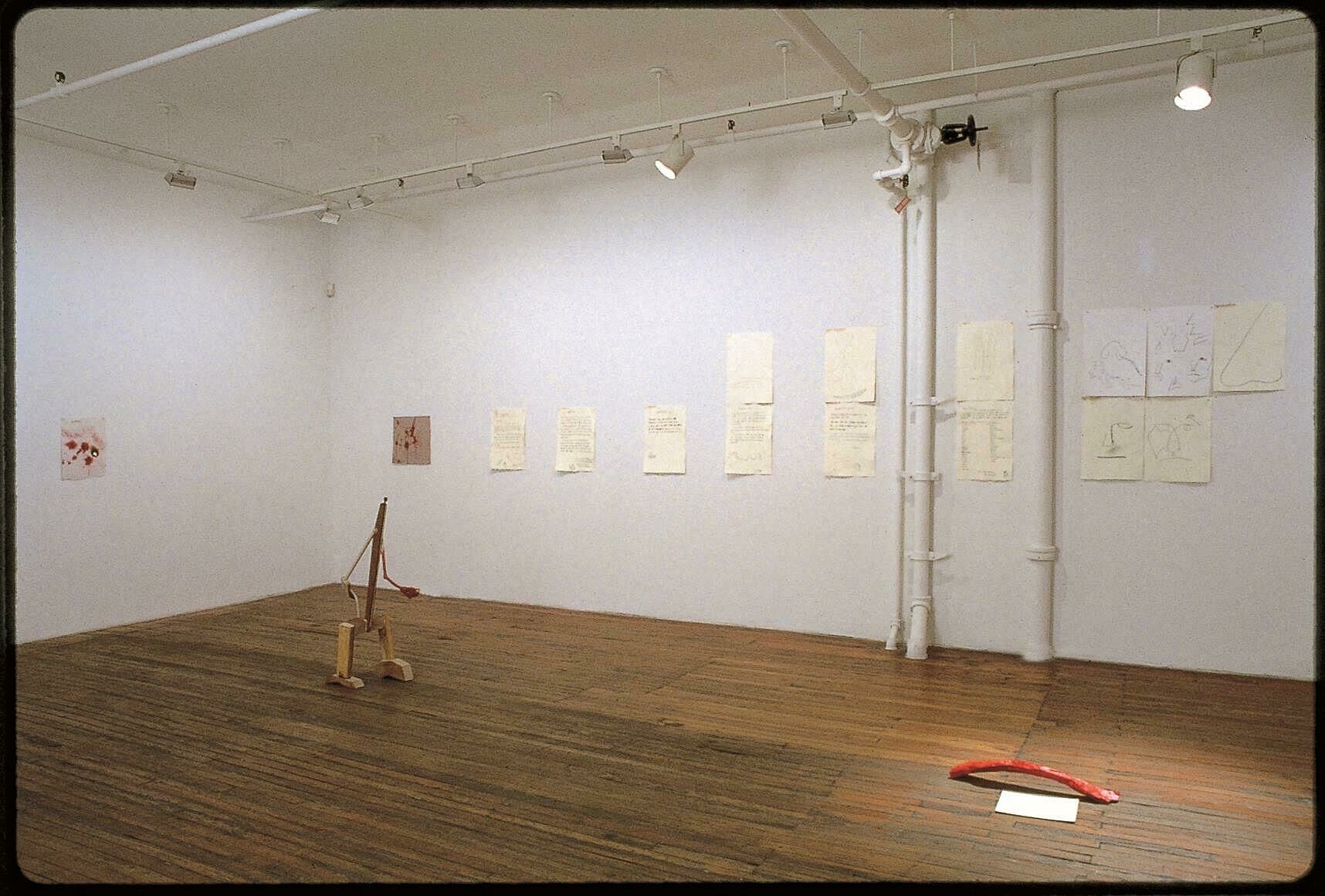 view of a room with pencil drawings on sheets of paper on the wall