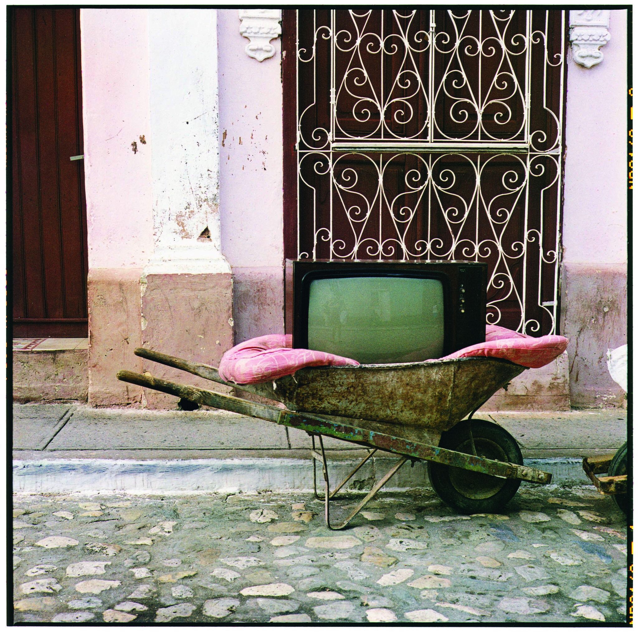 Wheelbarrow with TV set inside.