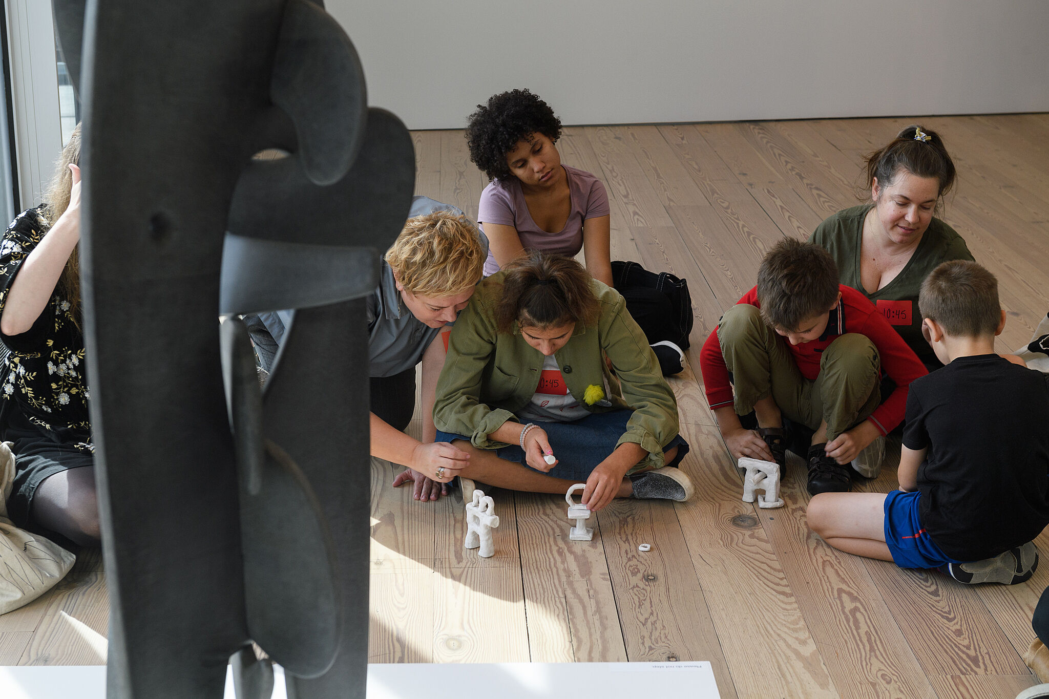 Families making sculptures together in the galleries.