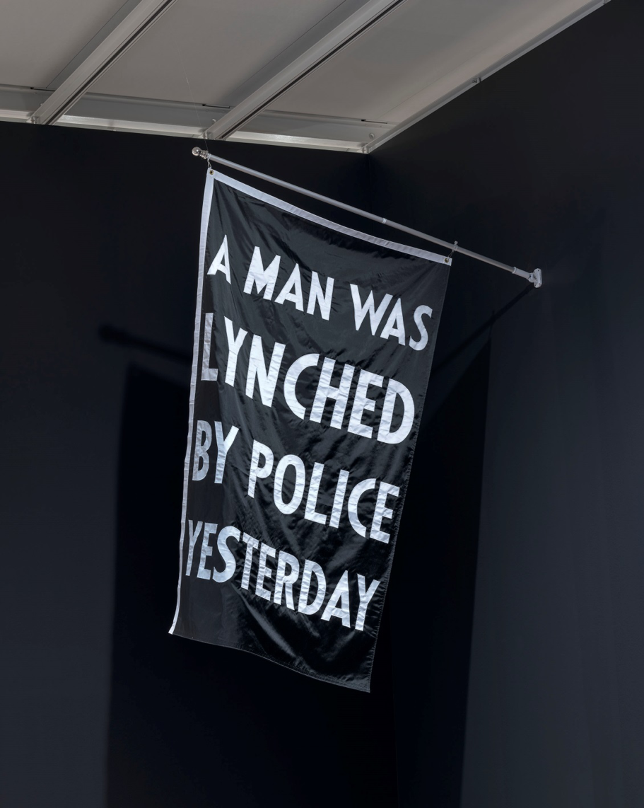 A banner that reads "A man was lynched by police yesterday"