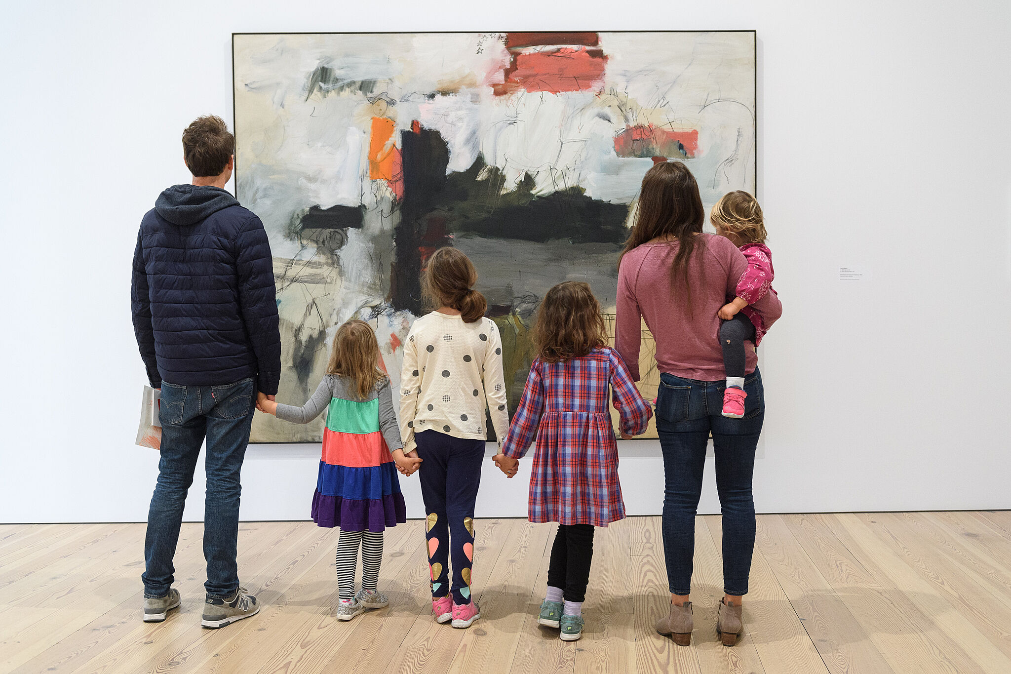 A family exploring an artwork together.