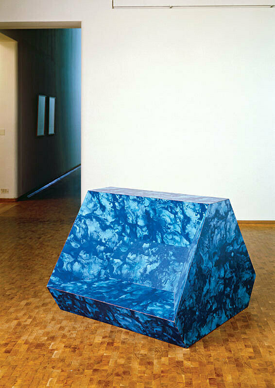 Large, blue-marble patterned geometric sculpture. 