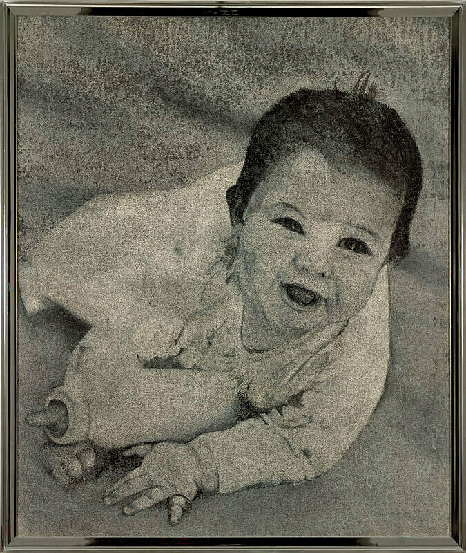 Large black and white photo of a baby with a bottle in an aluminum frame.