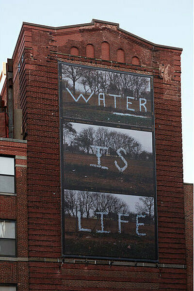 Building with "Water is Life" written on it.