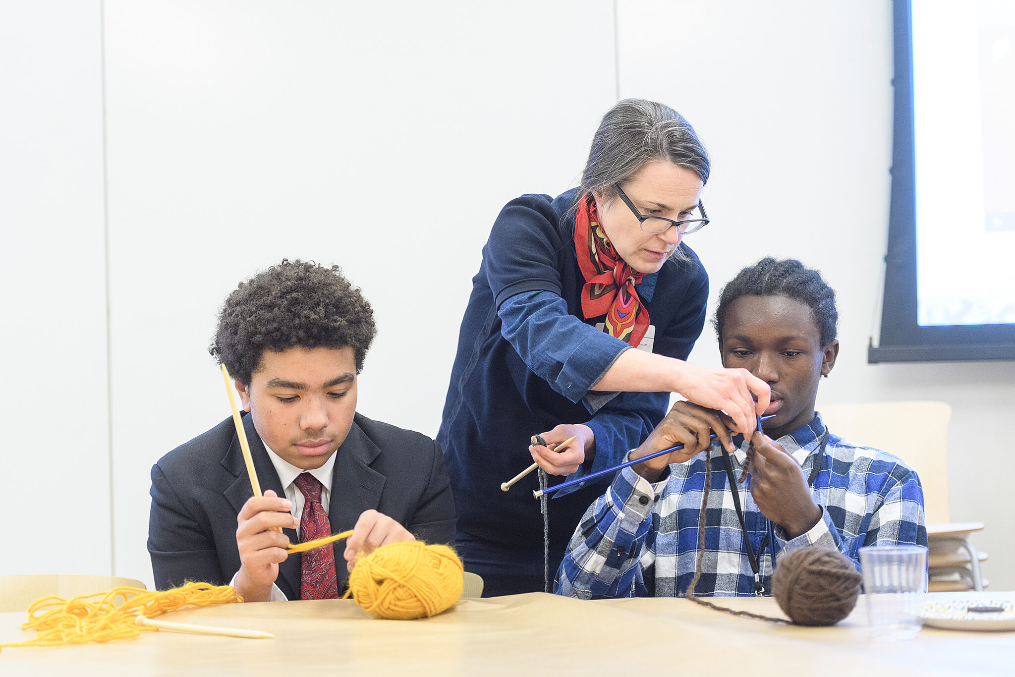 Teens learning to knit.