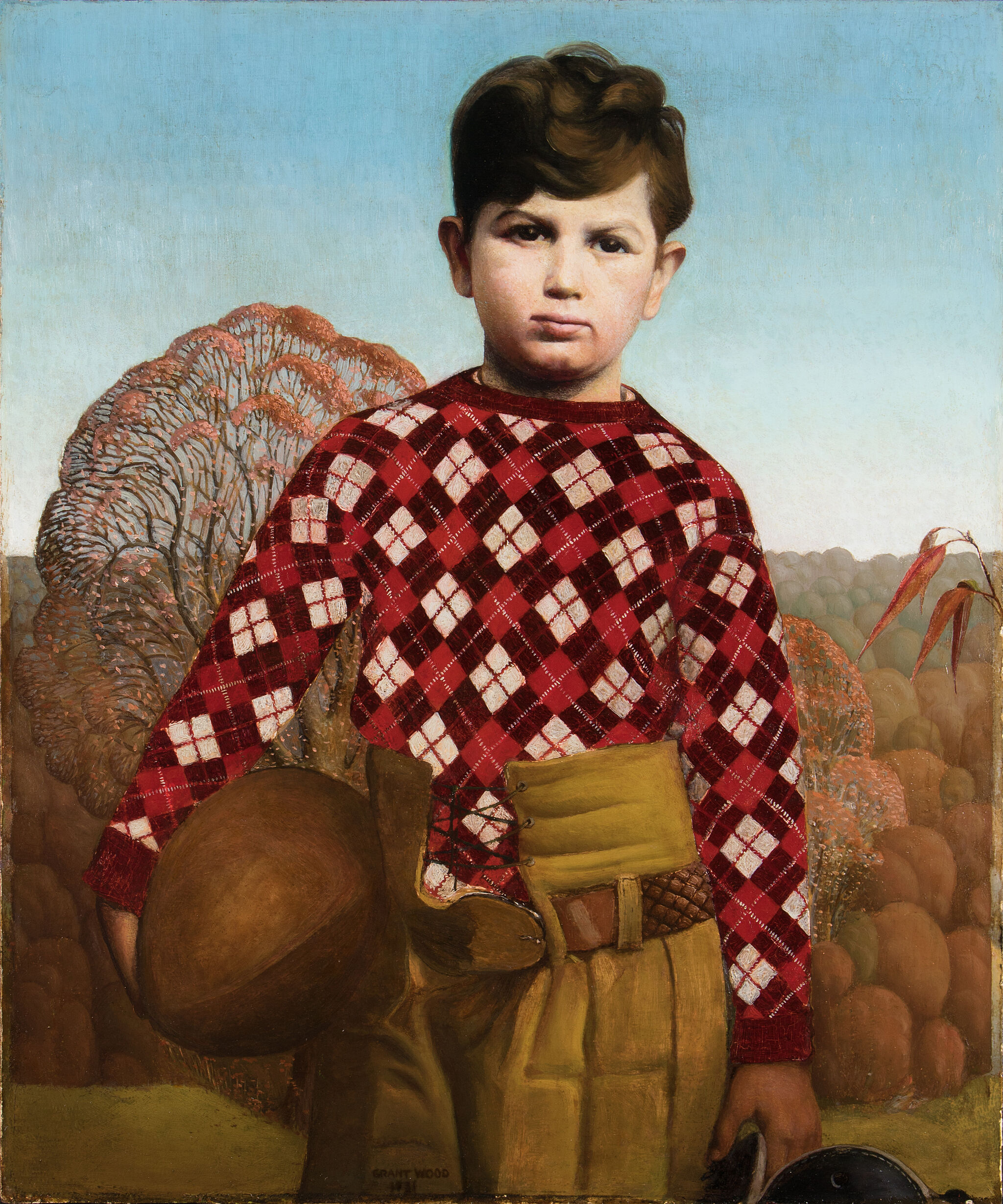 Portrait of a boy in a plaid sweater.