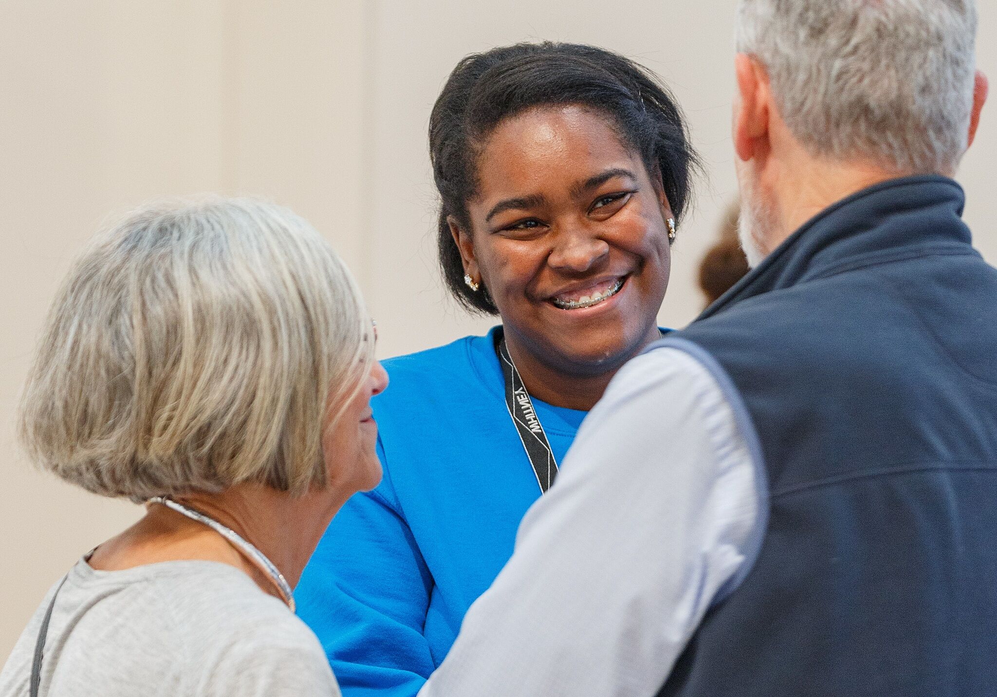 Museum employee greeting visitors.