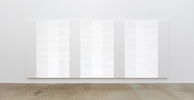 Three white paintings on a wall.