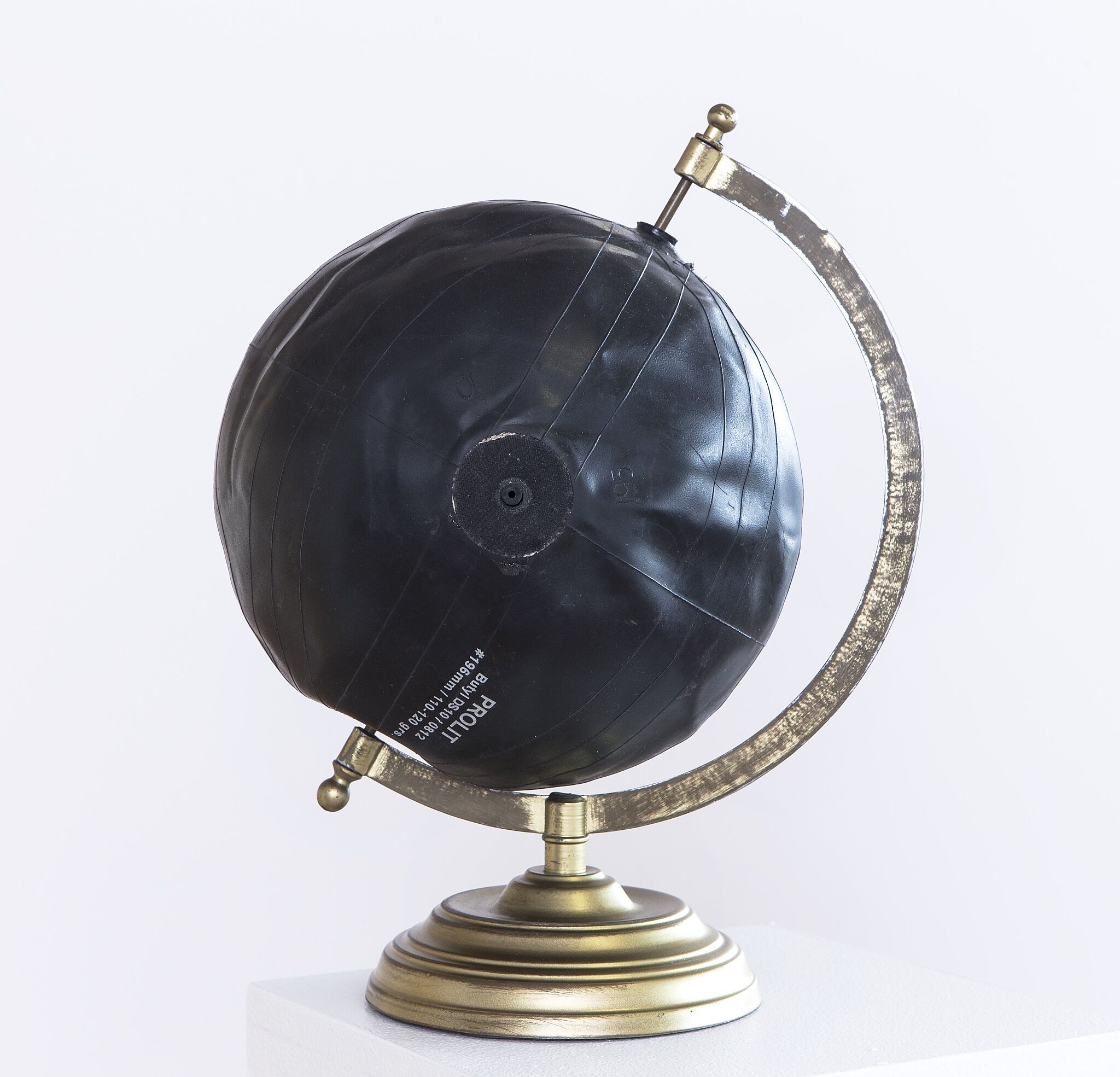 A black soccer ball as a globe. 