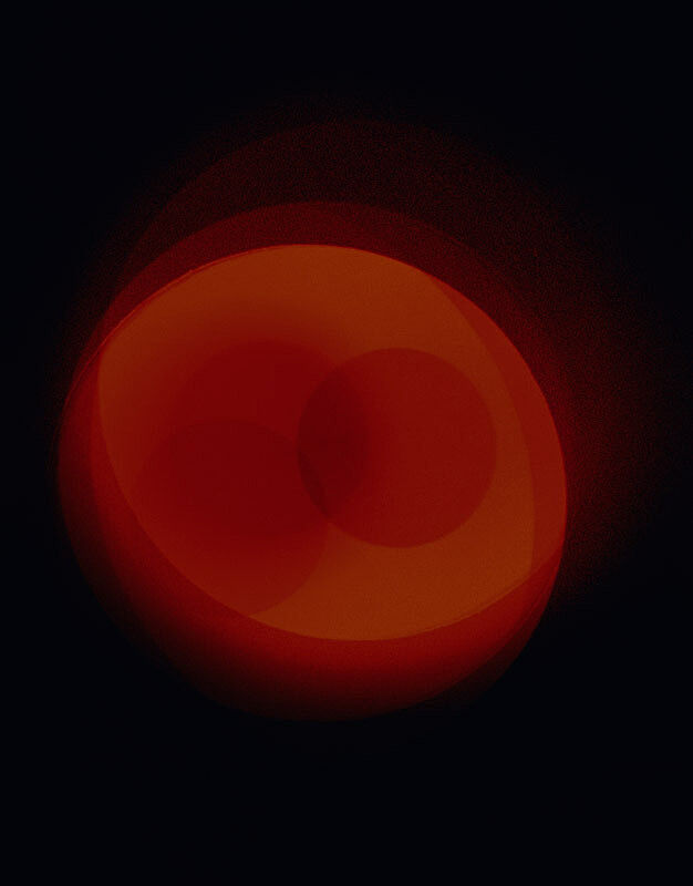 An image of a red circle in the middle of black background. 