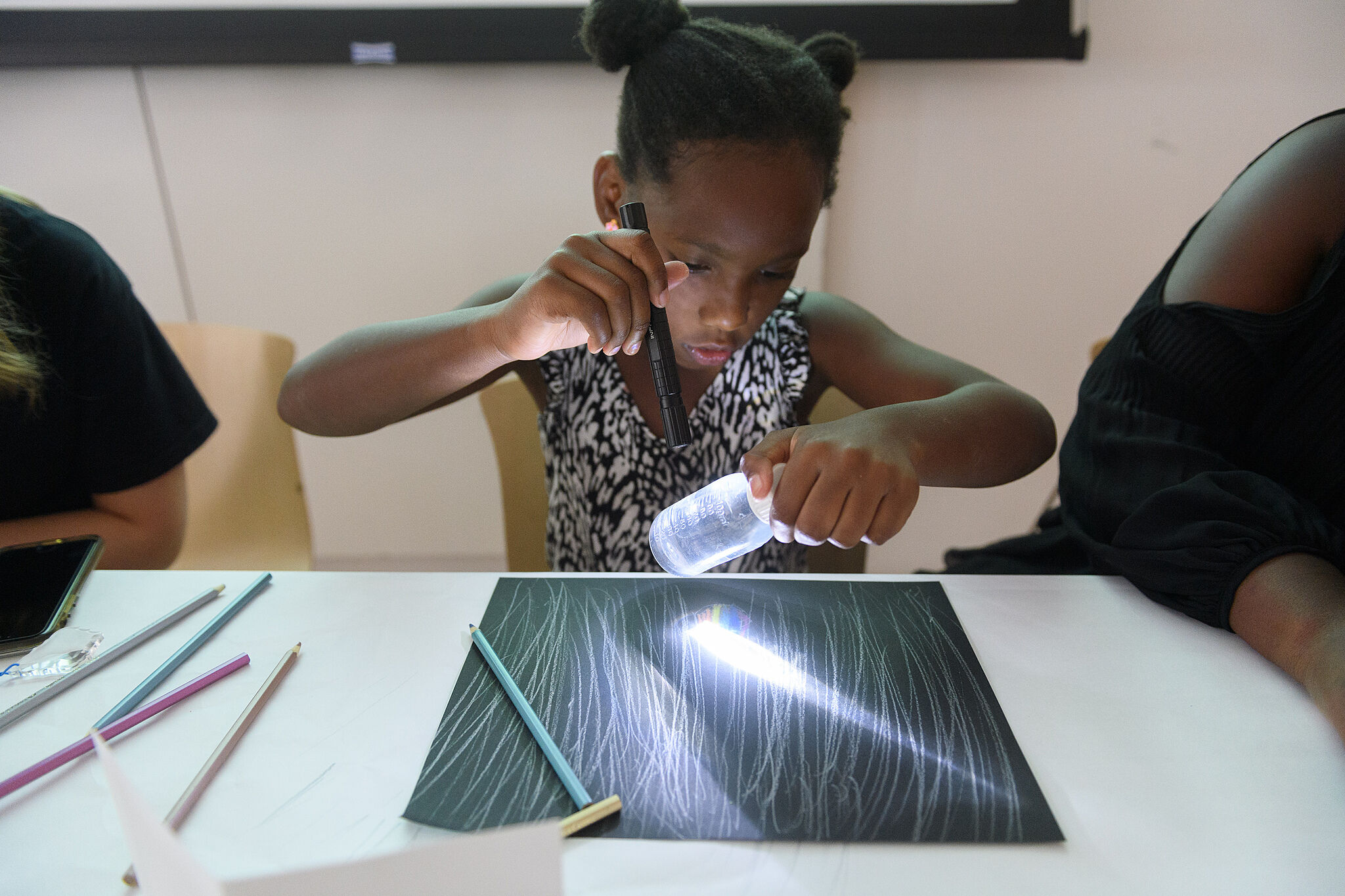 A kid making a drawing in Open Studio