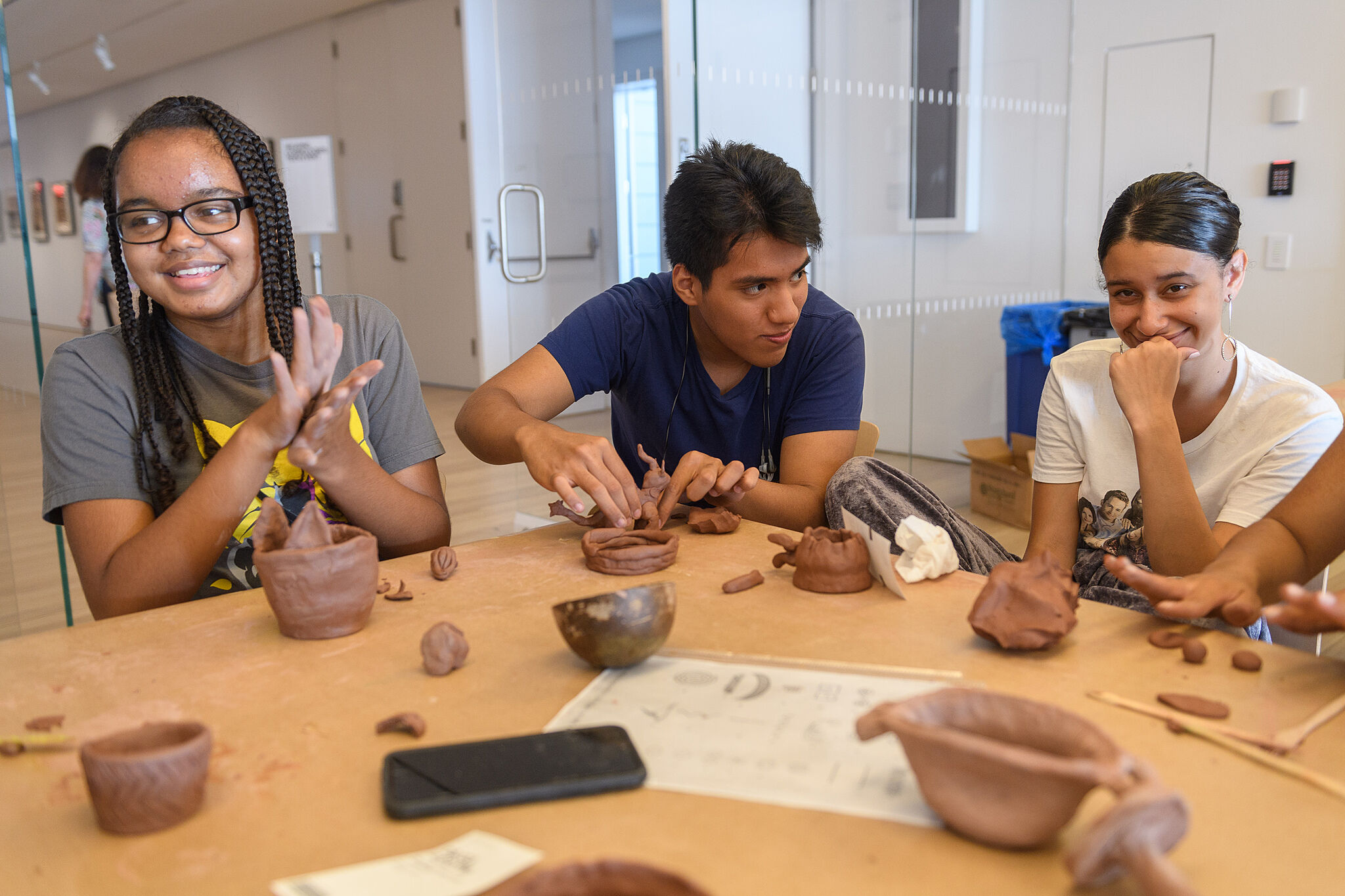 Teens participate in a pottery-making workshop led by Taíno pottery maker Alice Chéveres. 