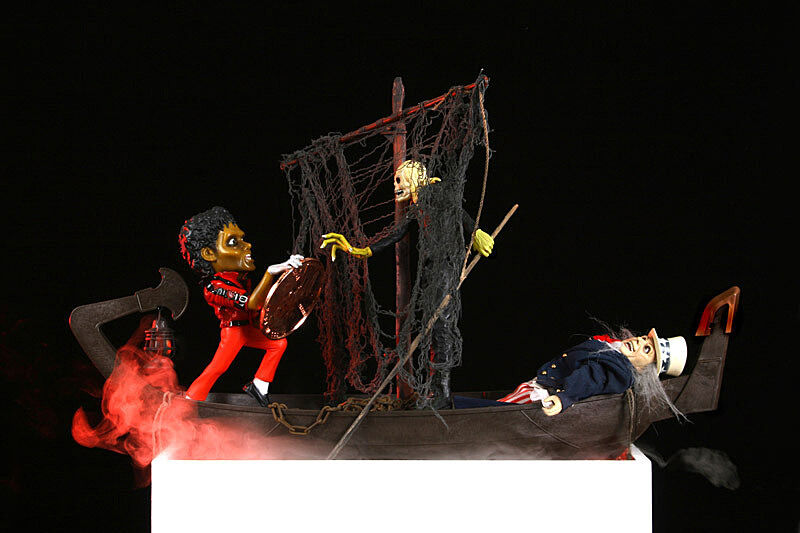 Figures of Michael Jackson and Uncle Sam on a boat. 