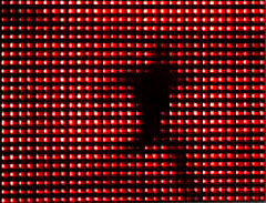 Red lights with a silhouette of a figure in black.