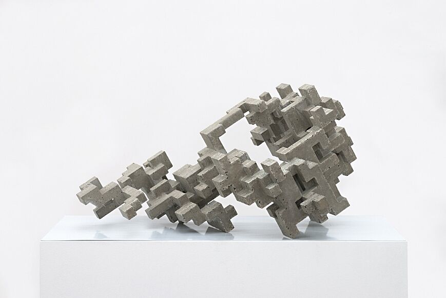 Sculpture made of gray cubes in abstract form.