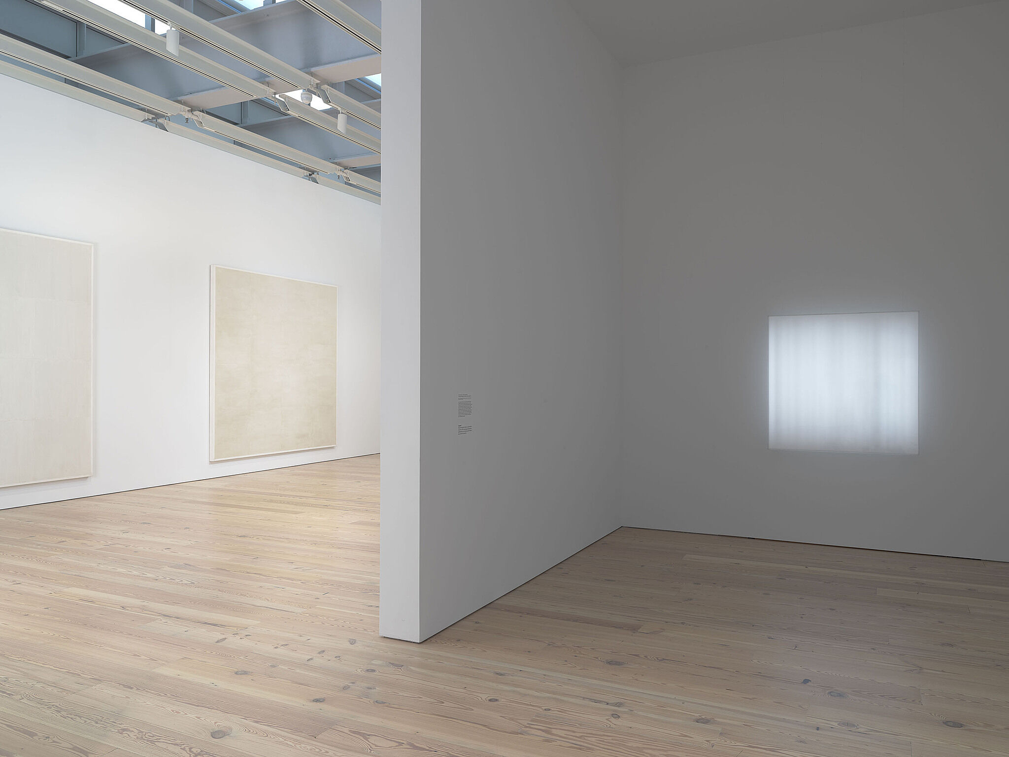 Installation view of Mary Corse: A Survey in Light, including Untitled (White Grid, Vertical Strokes), 1969; Untitled (White Grid, Horizontal Strokes), 1969; Untitled (Space + Electric Light), 1968.