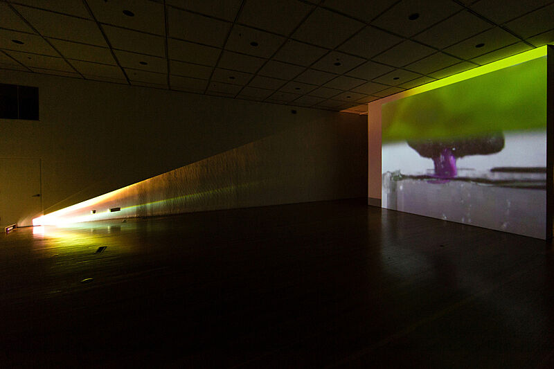 Installation view of video projecting on a wall. 