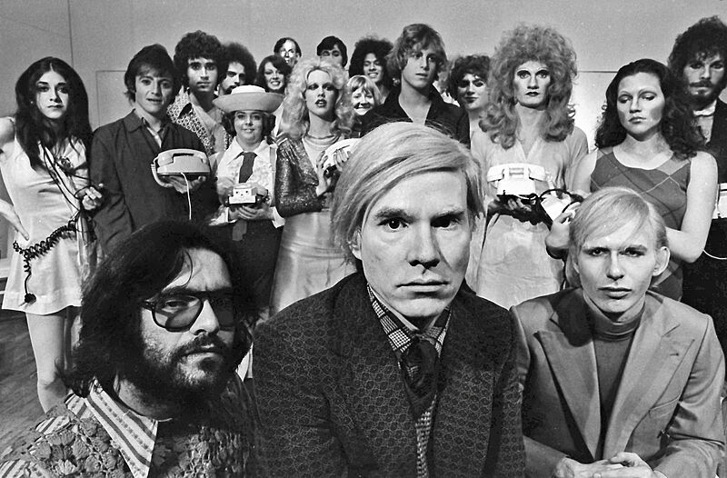 A black and white photograph of Andy Warhol and his cast. 