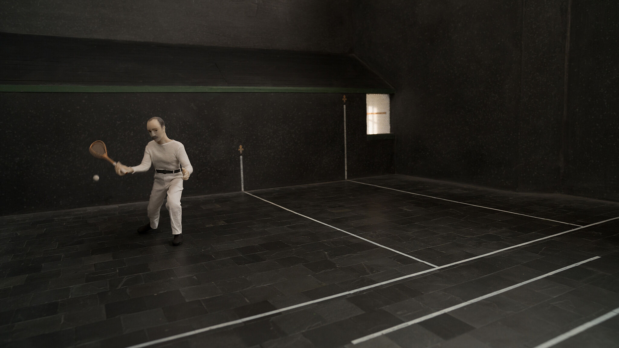 A still from an animation of a man playing tennis. 