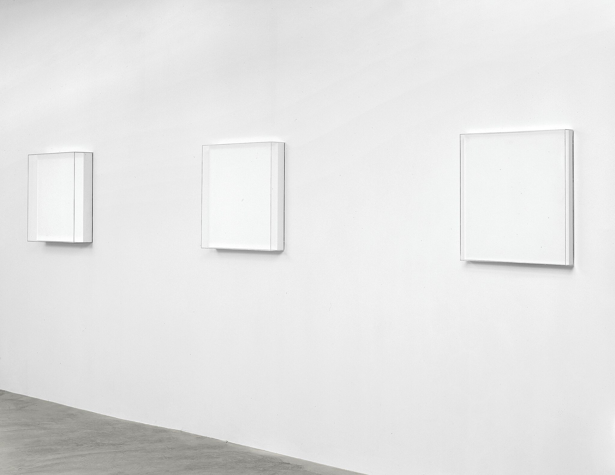 Three white square artworks.