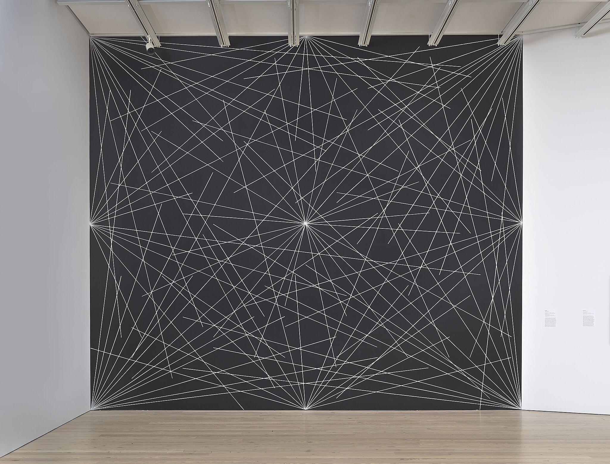 A black wall with white drawn lines.