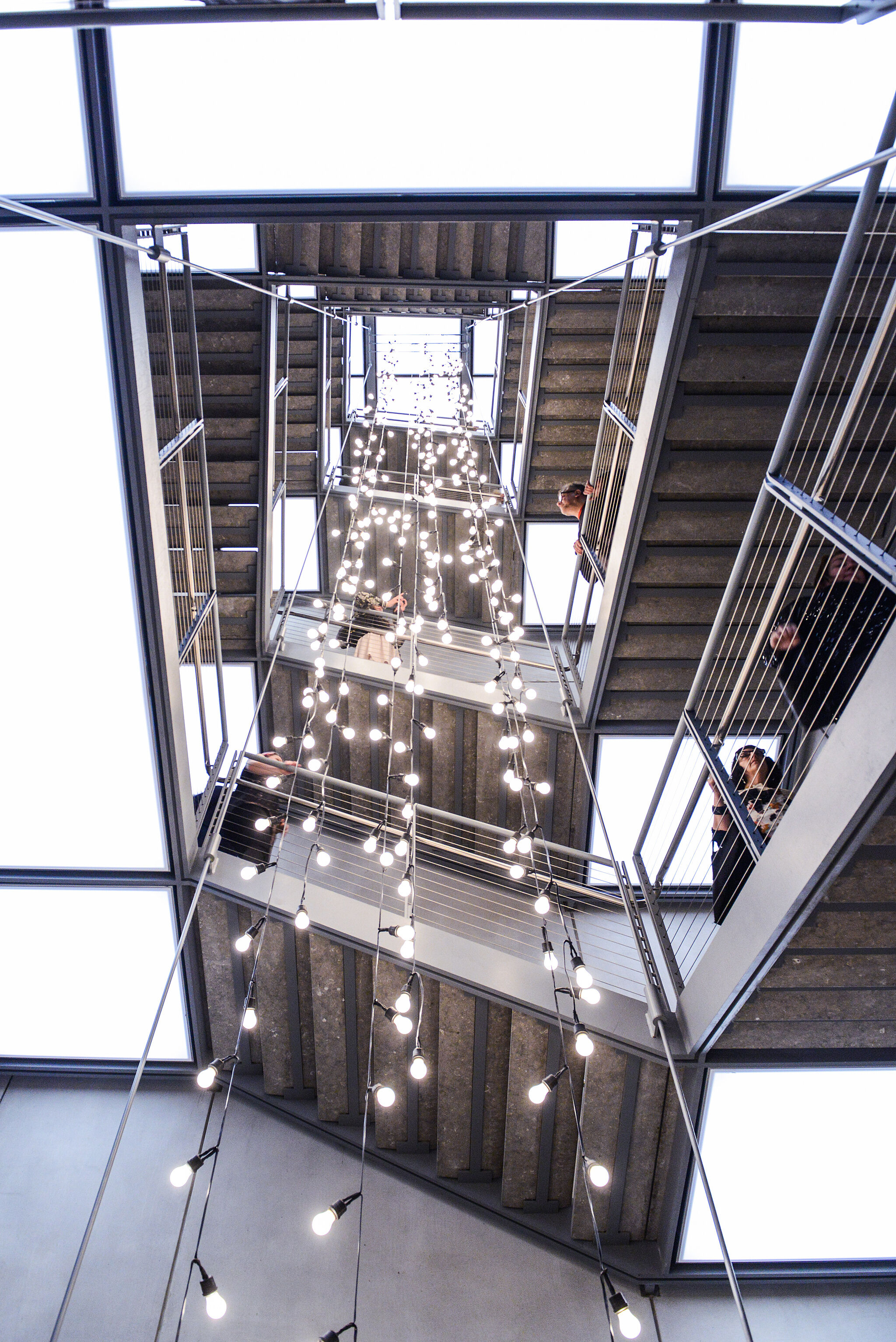 An installation in the Whitney's stairwell featuring white string lights.