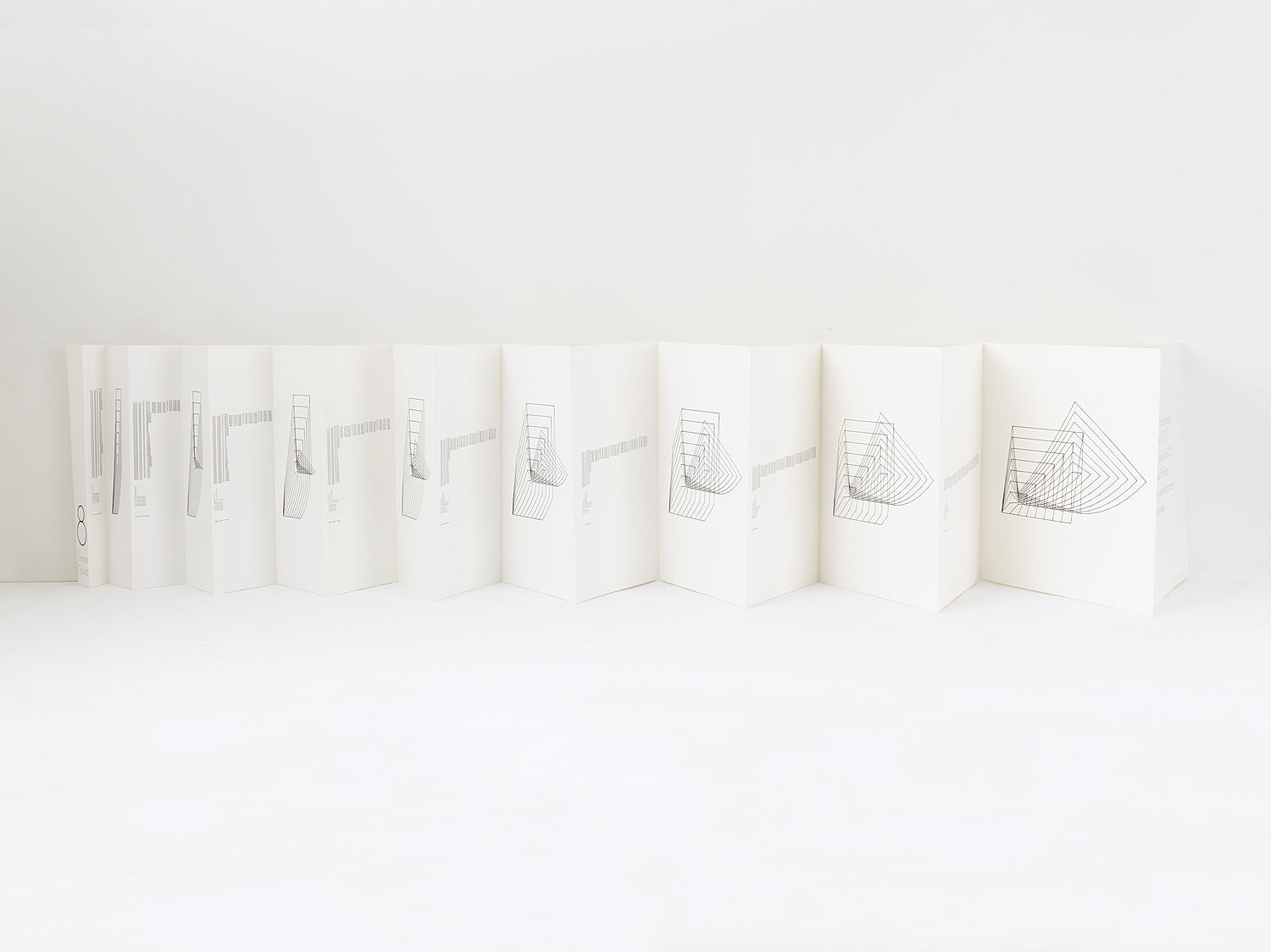 Folded papers with a geometric drawing on them.