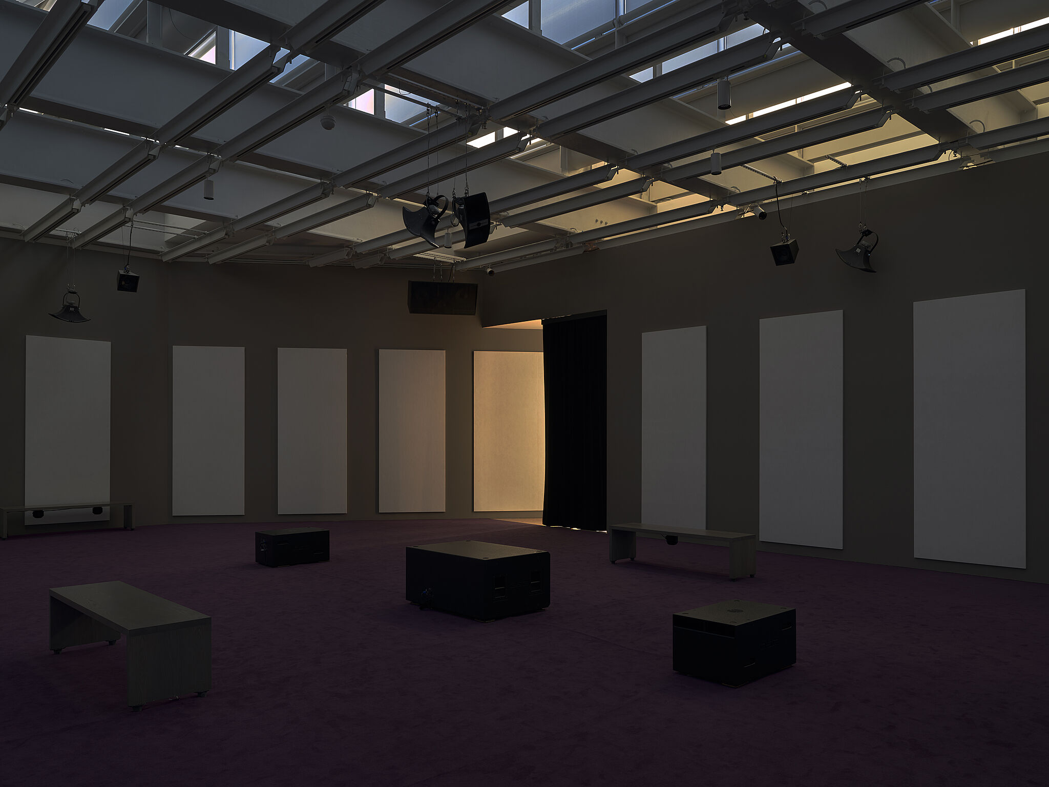 Audio equipment in a dimly lit gallery space.