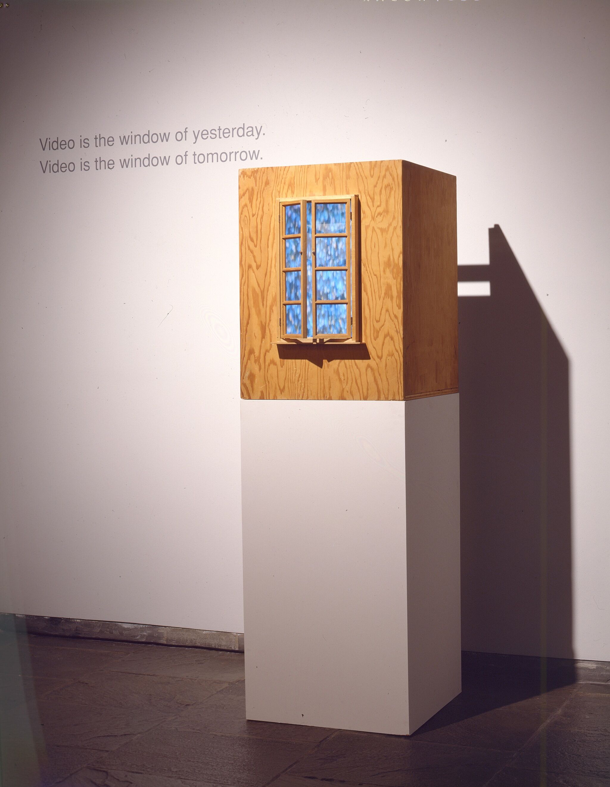 A wooden box with doors that open onto a screen.