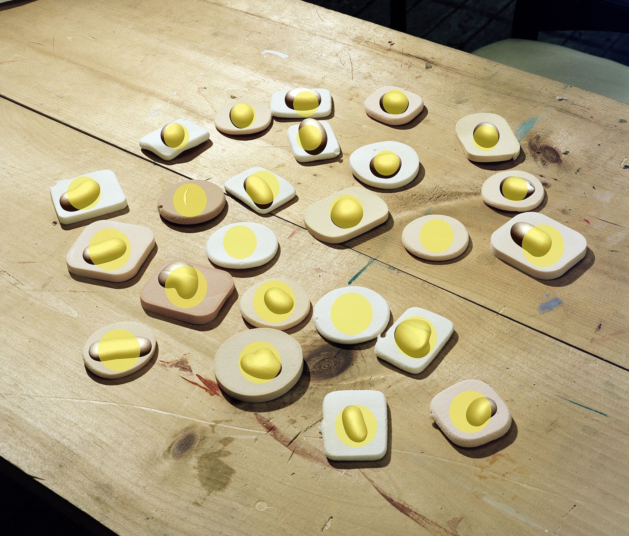 A print of digital halved eggs on a wooden table.