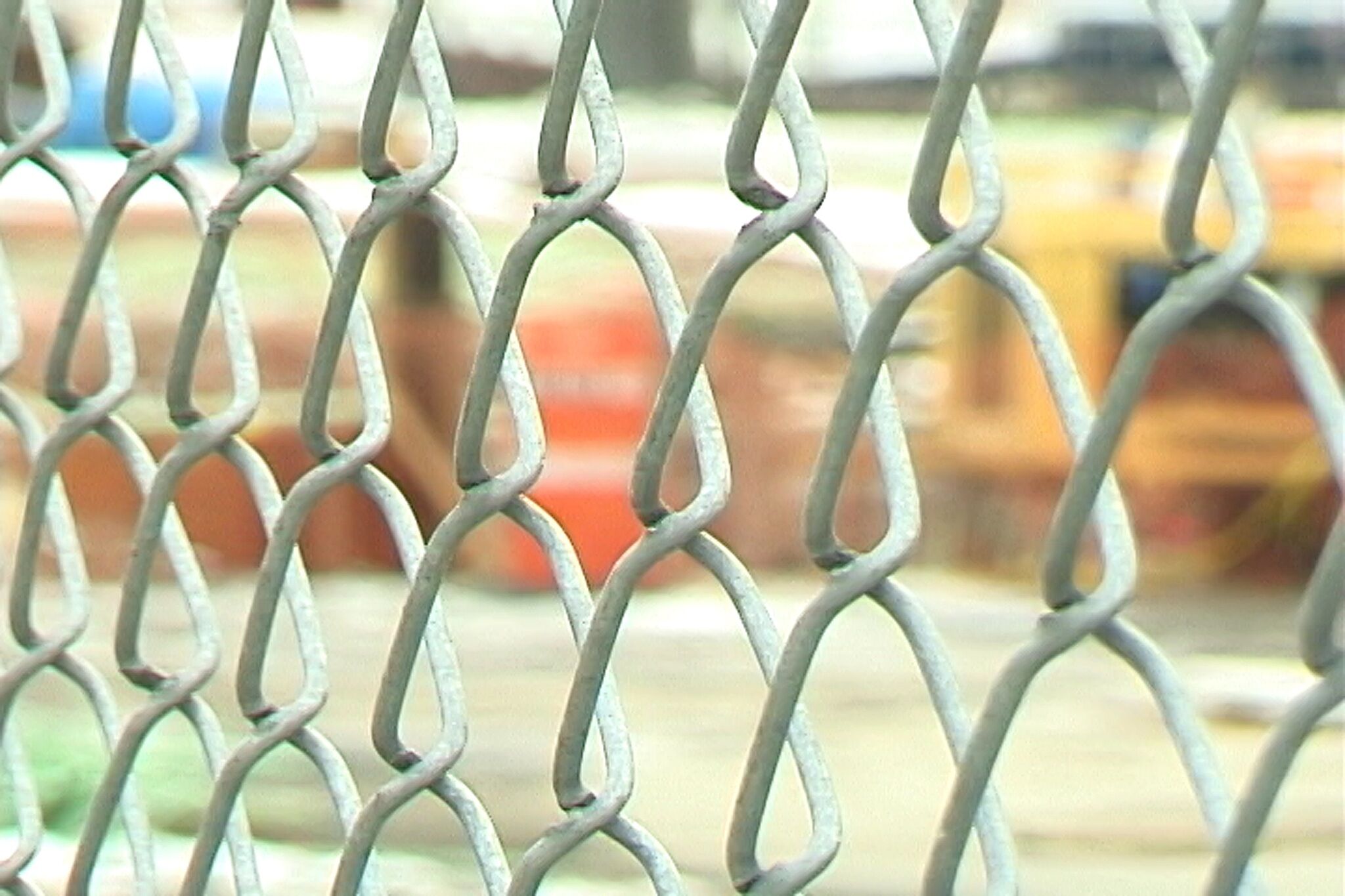 A video still of a wire fence up close.