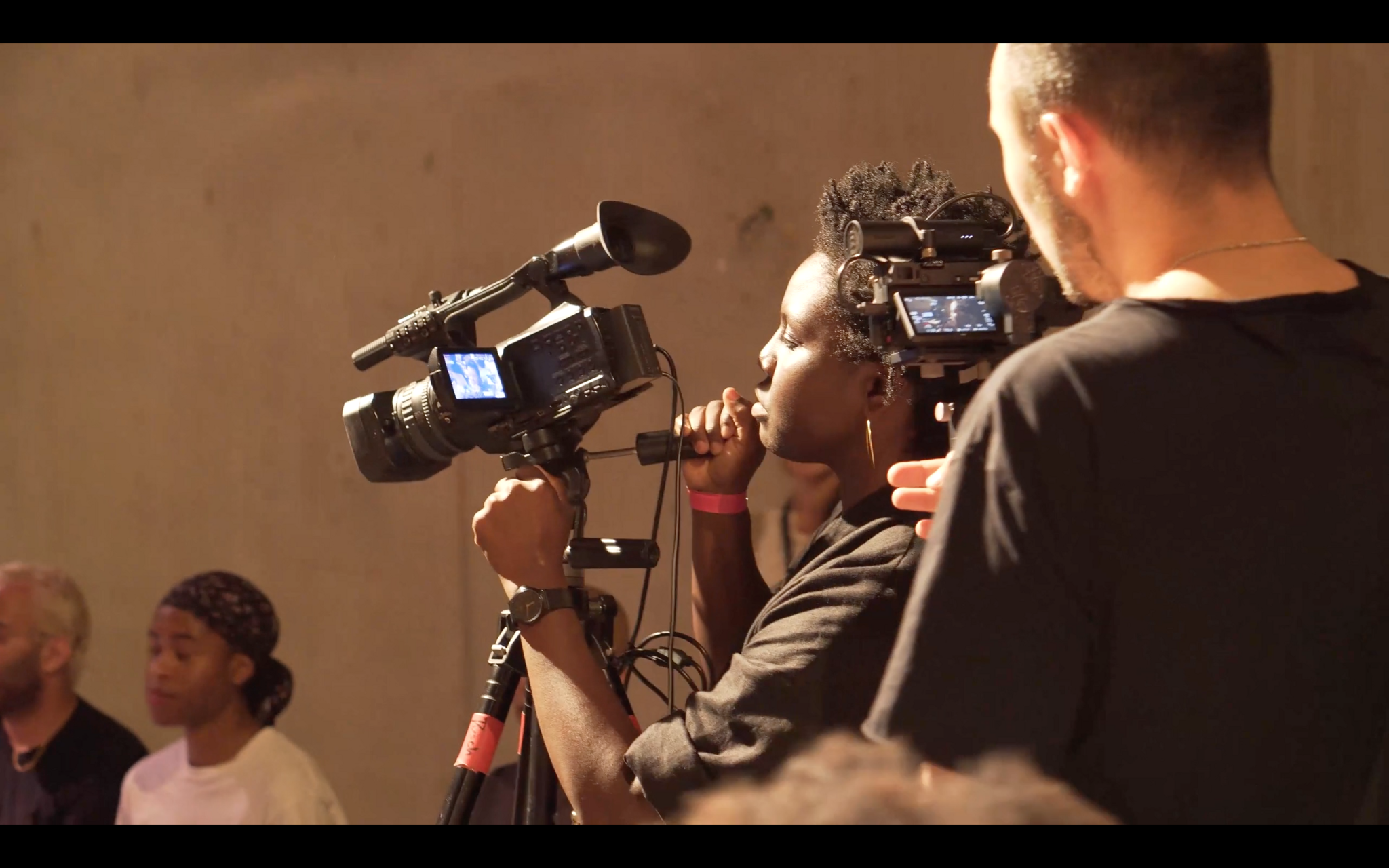 A woman using a film camera.