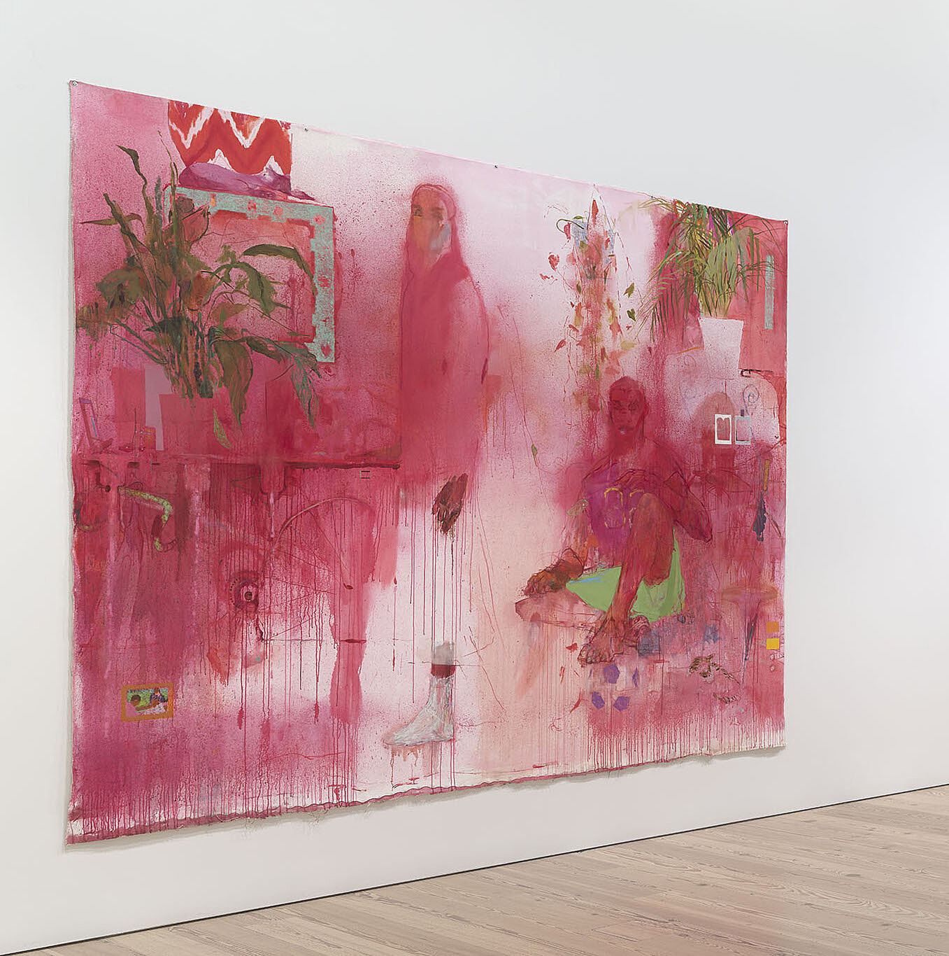 An installation view of a bright pink painting with two figures in a gallery.