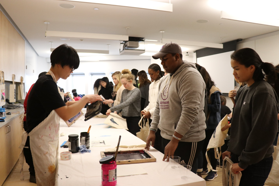 A photograph of youth working at a printshop.