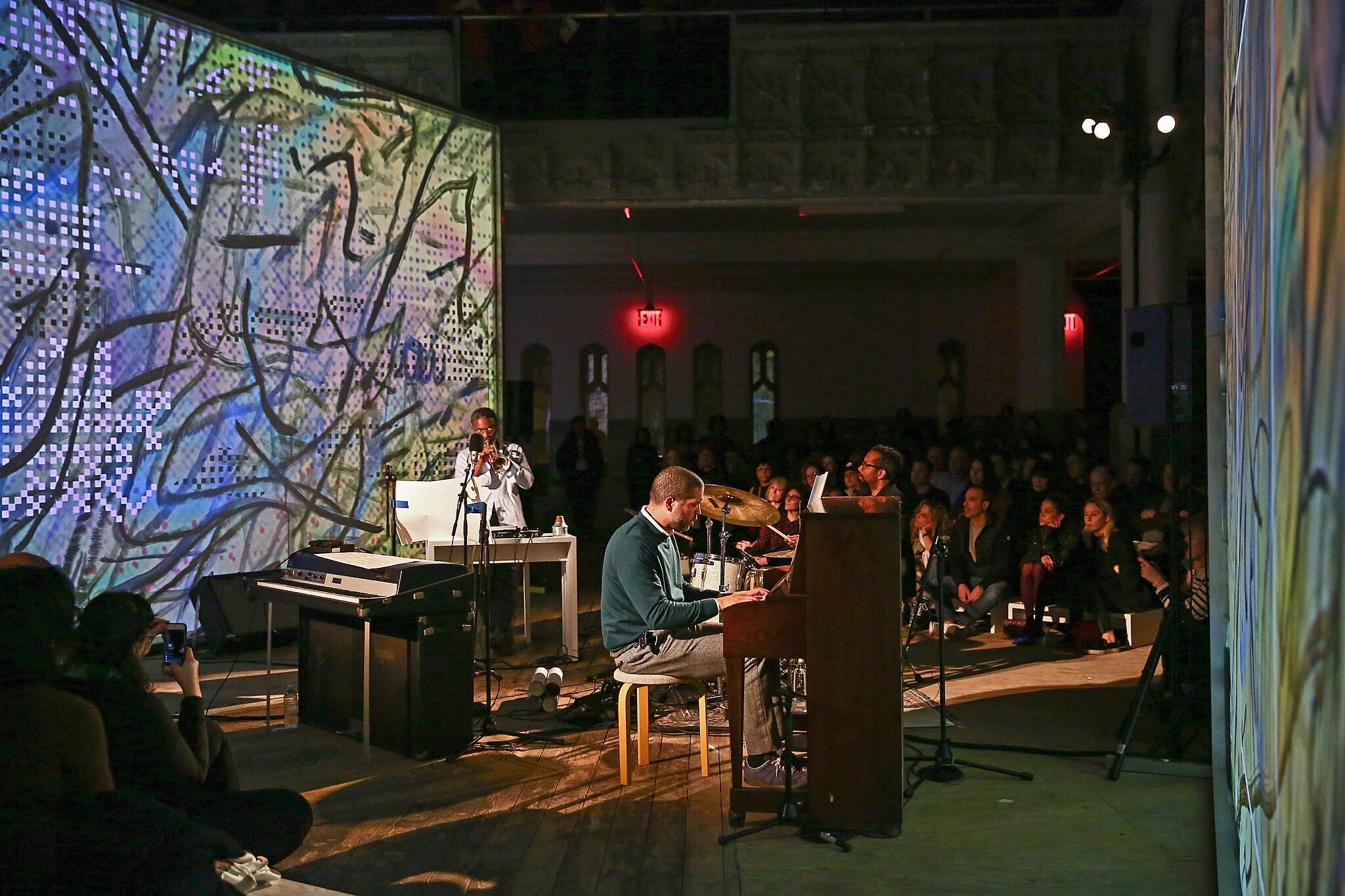 A live performance including a man at a piano.