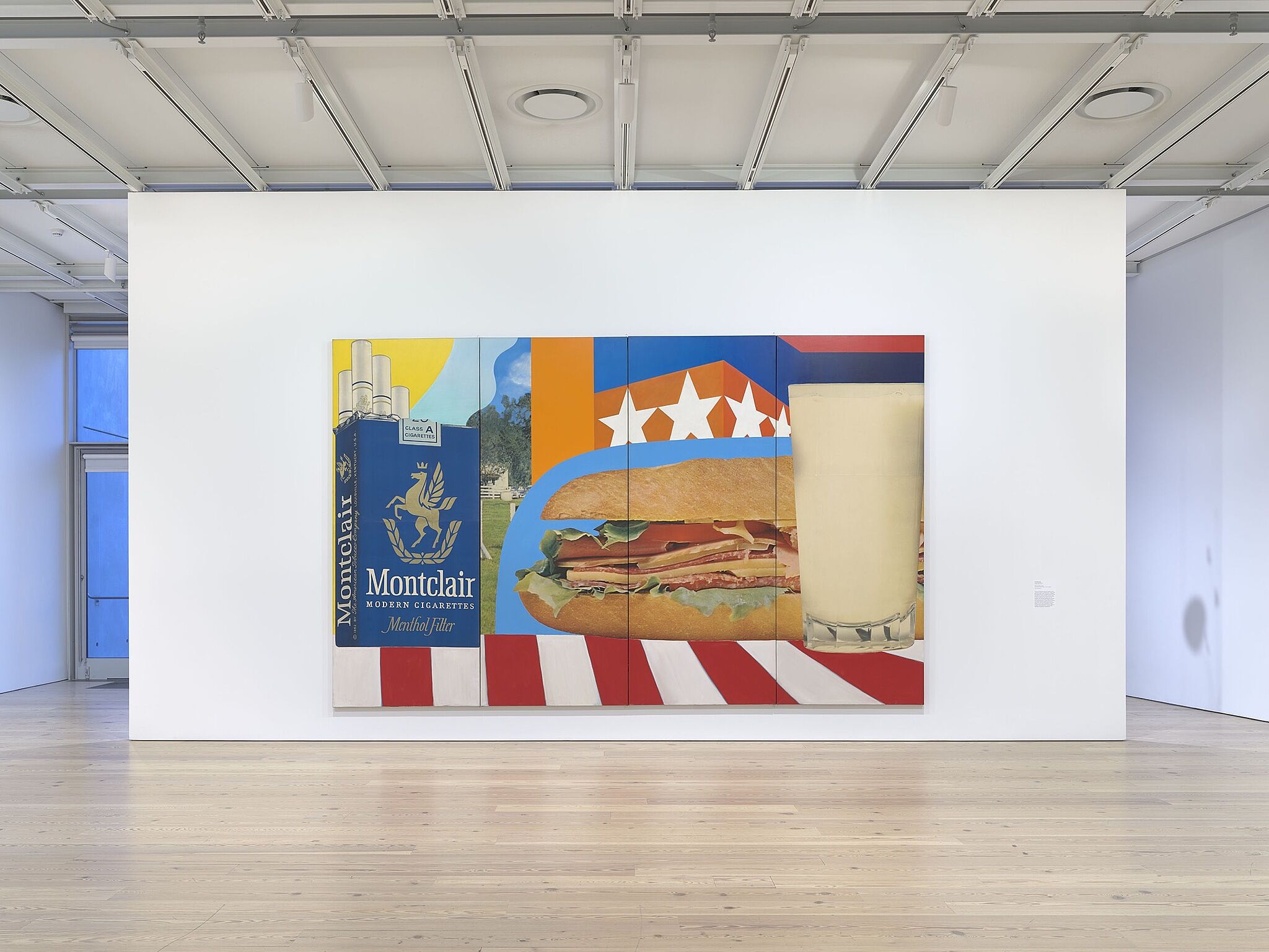 An image of the Whitney galleries with a large wall artwork