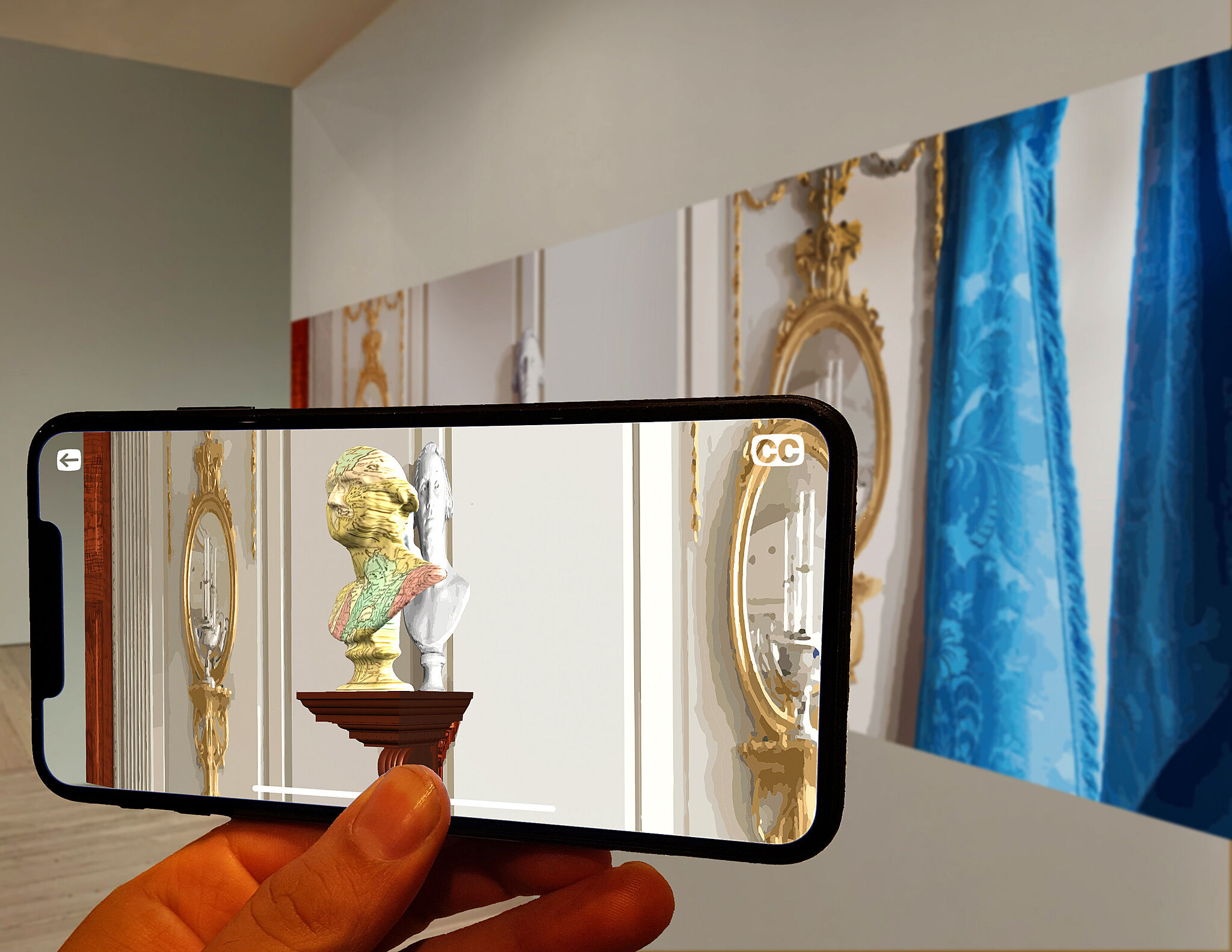 A person's hand holding a smartphone in front of a large print, which displays an augmented reality view of a classical bust statue on a pedestal. 