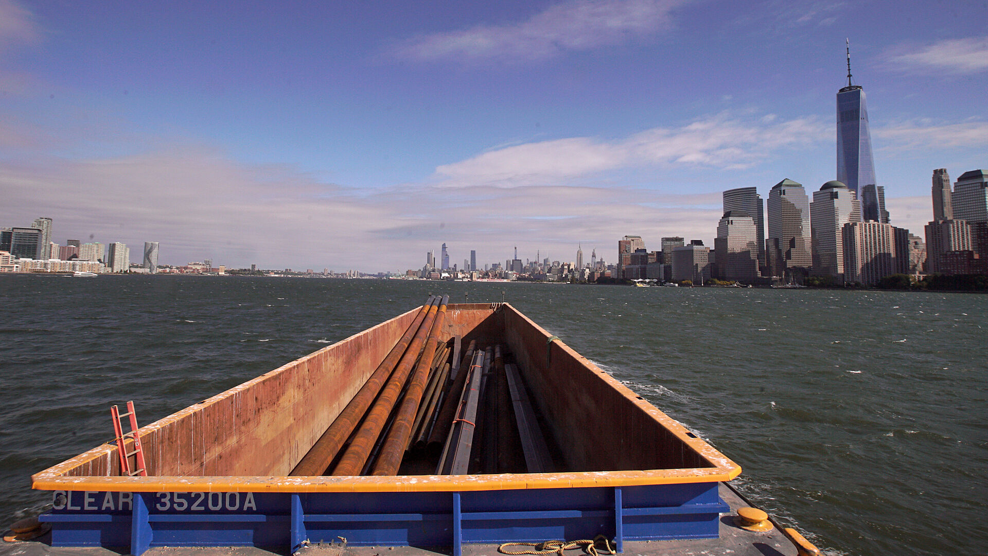 Photograph of a barge delivering materials on the Hudson River