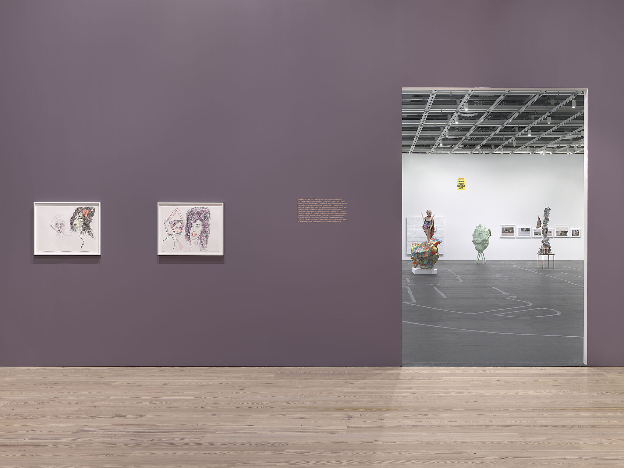 An image of the Whitney galleries with various sculptures and artworks on the walls.