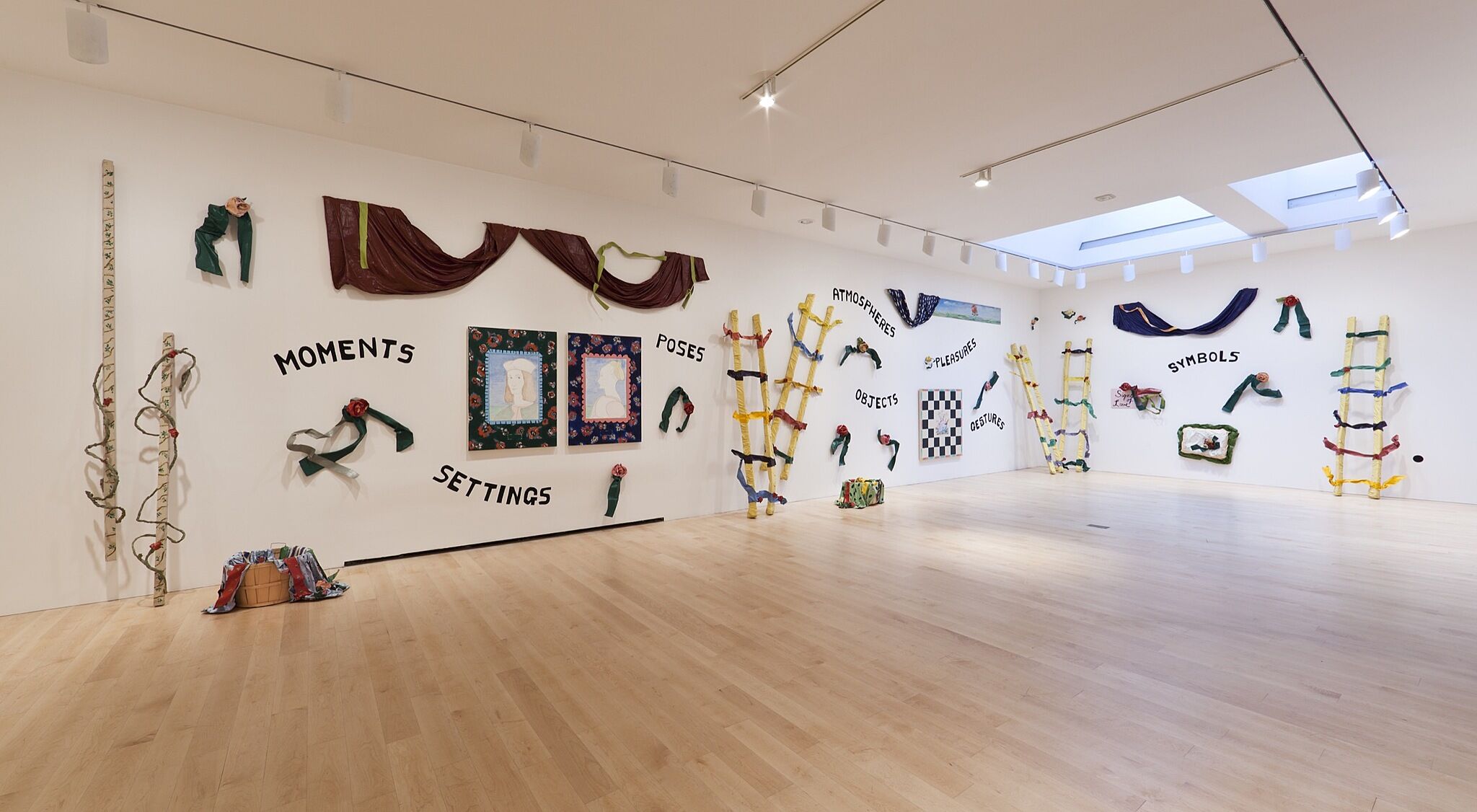 A collection of signs and textiles on a wall.