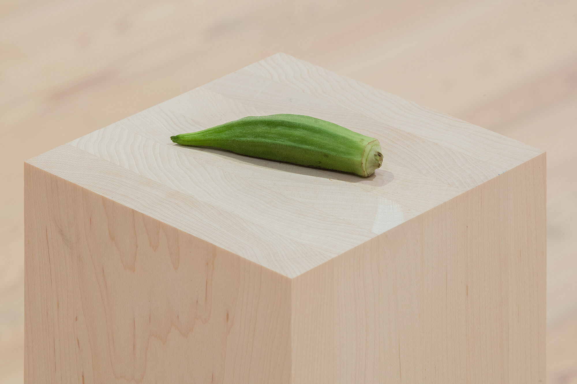 A photo of okra on a plinth.