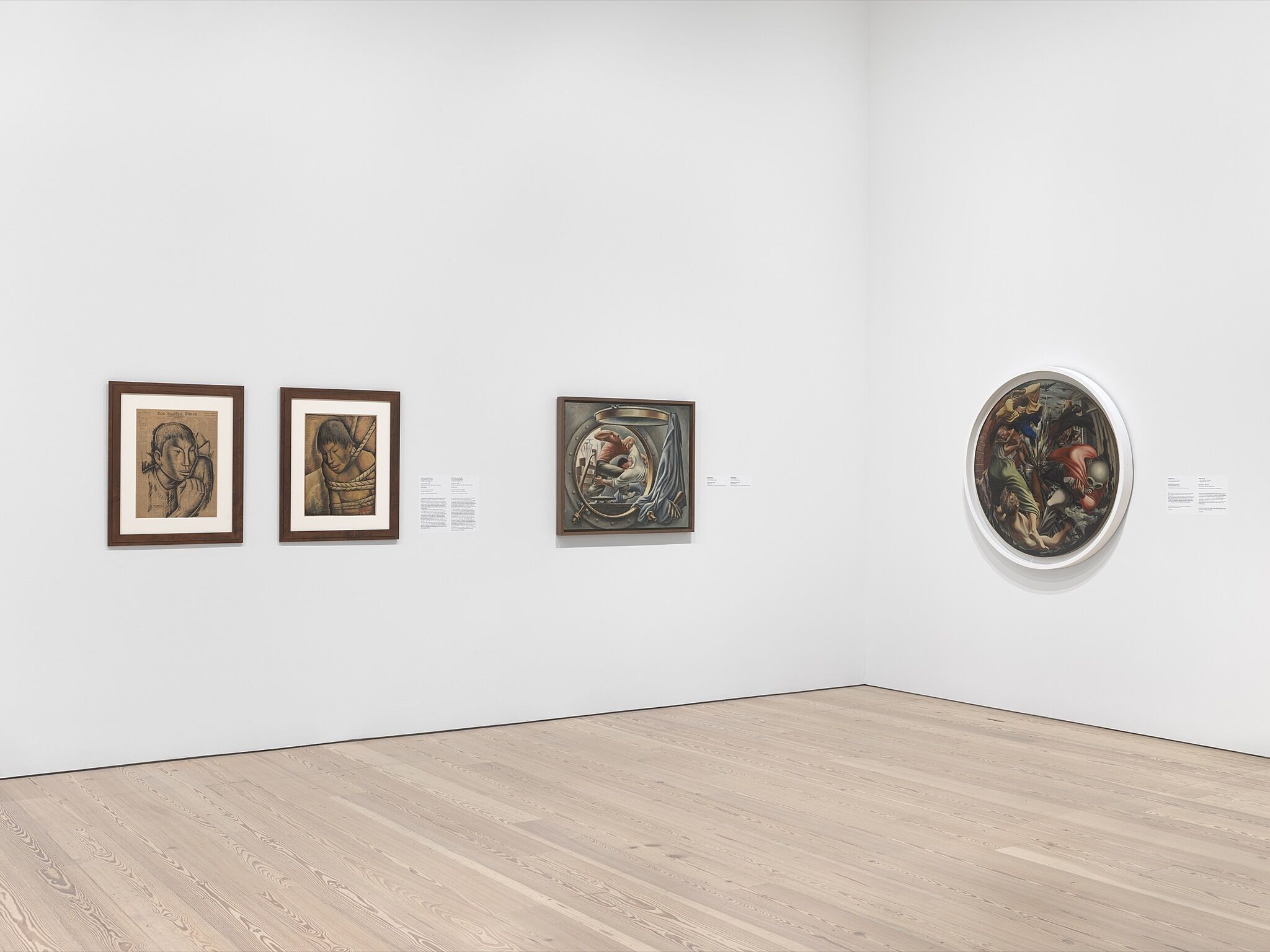 An installation photograph of a gallery with four medium-sized paintings.