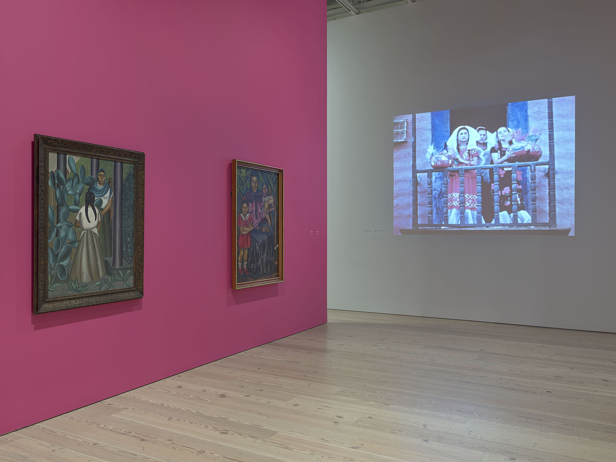A photo of the Whitney galleries with paintings on the walls.