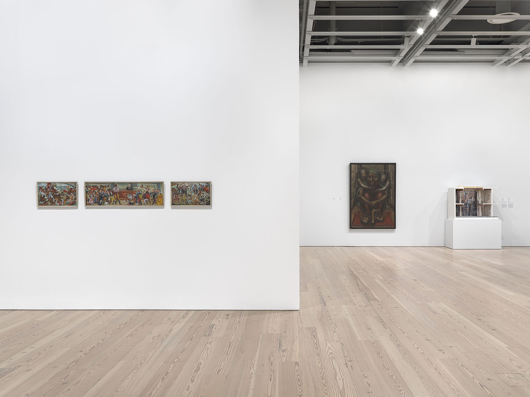 A photo of the Whitney galleries with paintings on the walls.