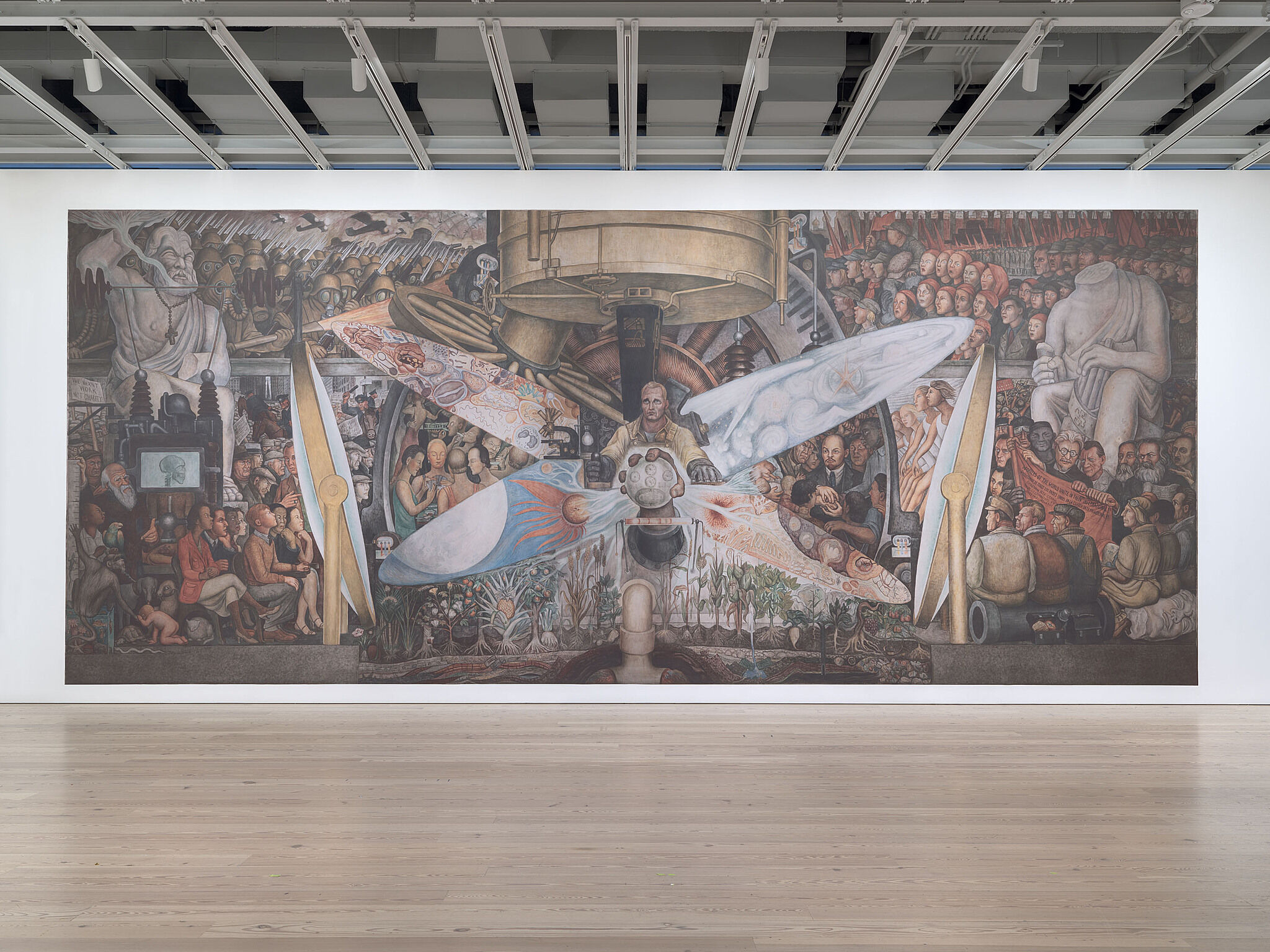 A photo of the Whitney galleries with a large mural reproduction on the wall.