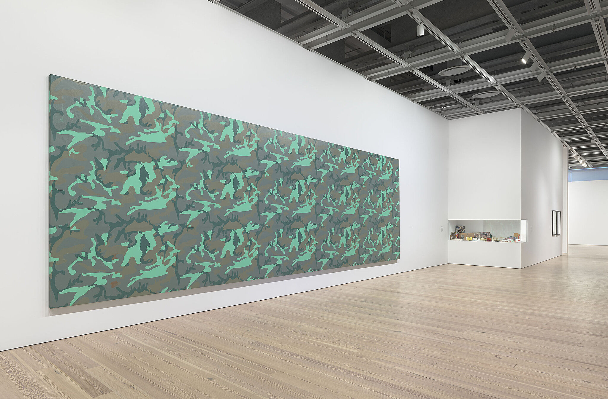 A photo of the Whitney galleries with a large painting on the wall.