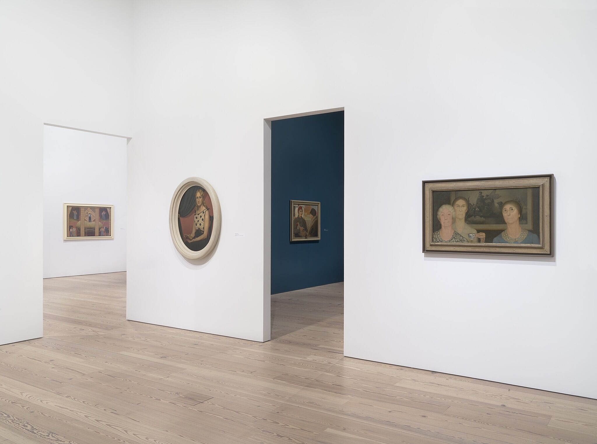 A photo of the Whitney galleries with various paintings.
