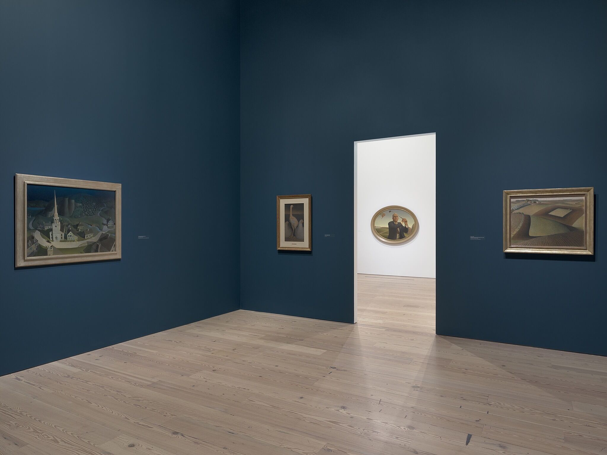 A photo of the Whitney galleries with various paintings.