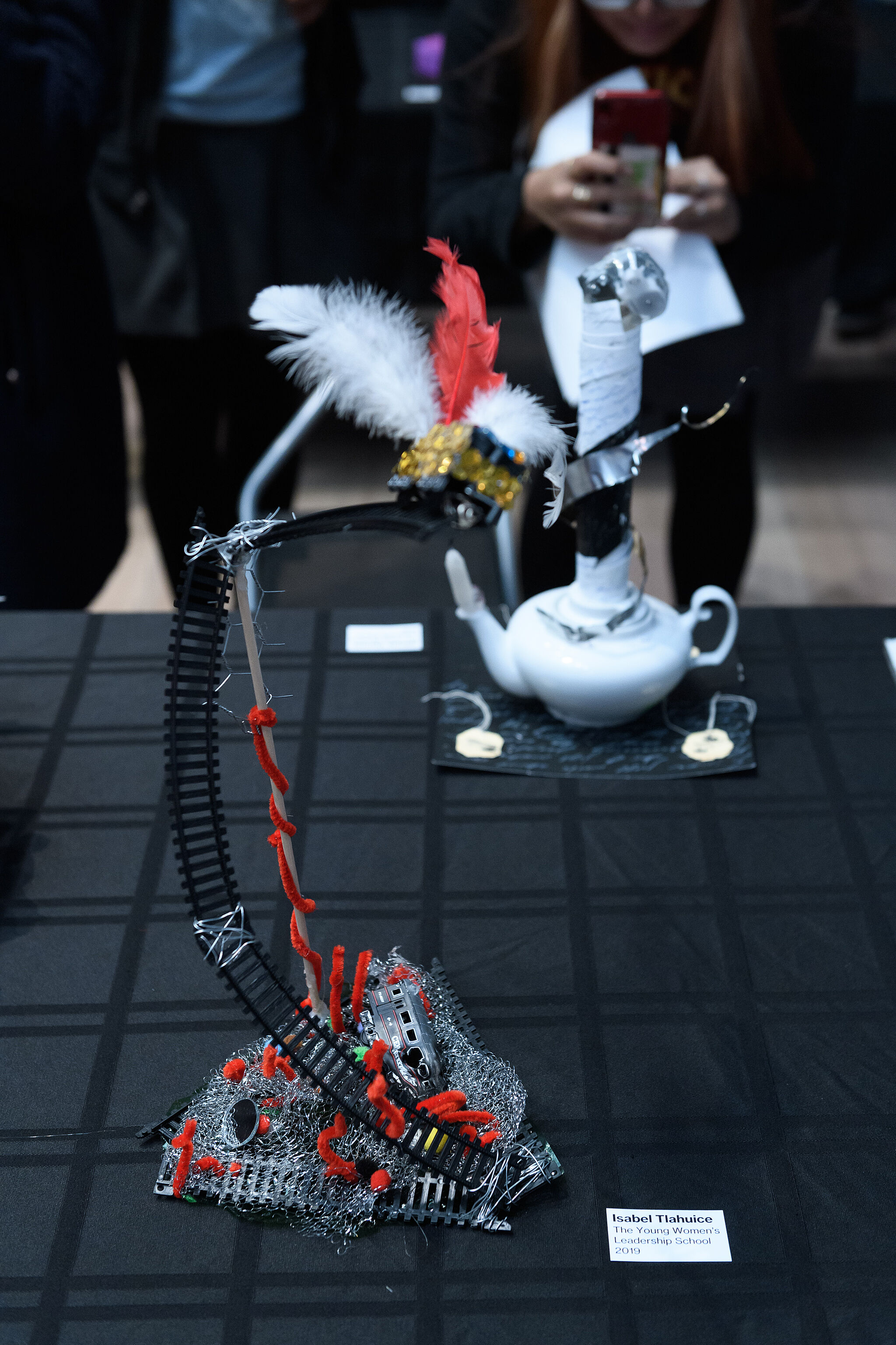 YI Artists present their artworks featuring a tea pot and a sculpture with feathers and pipe cleaners, spring 2019. 