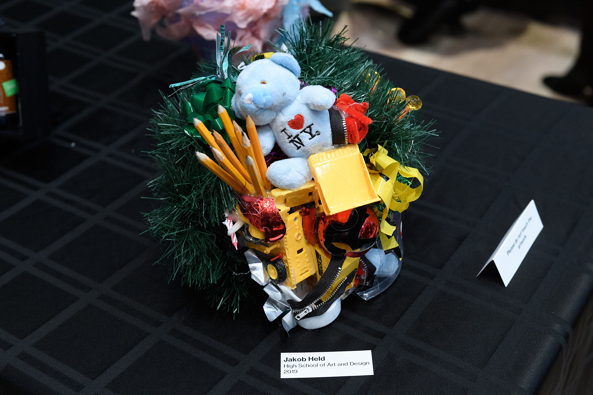 YI Artist, Jakob Held, displays his piece featuring pencils, toys, and bows, spring 2019